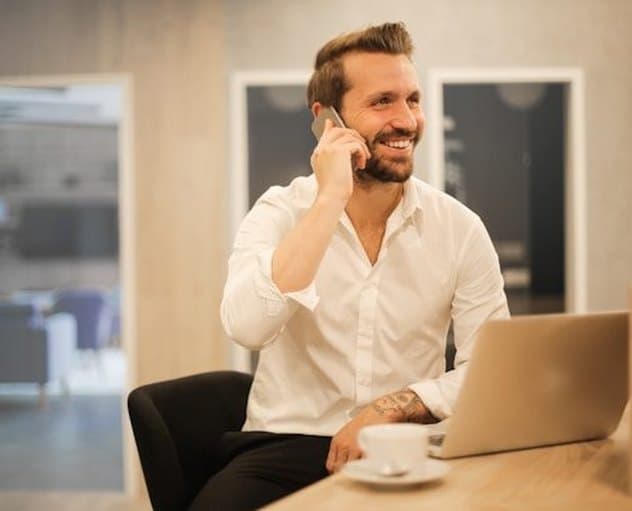 A colleague on a call at their desk